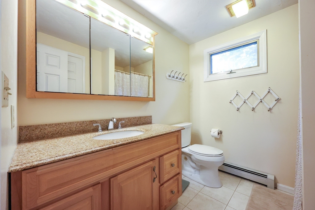 4 Rainbow Drive Medway, MA 02053 - Photo 23 of 42 a bathroom with a granite countertop toilet sink and mirror
