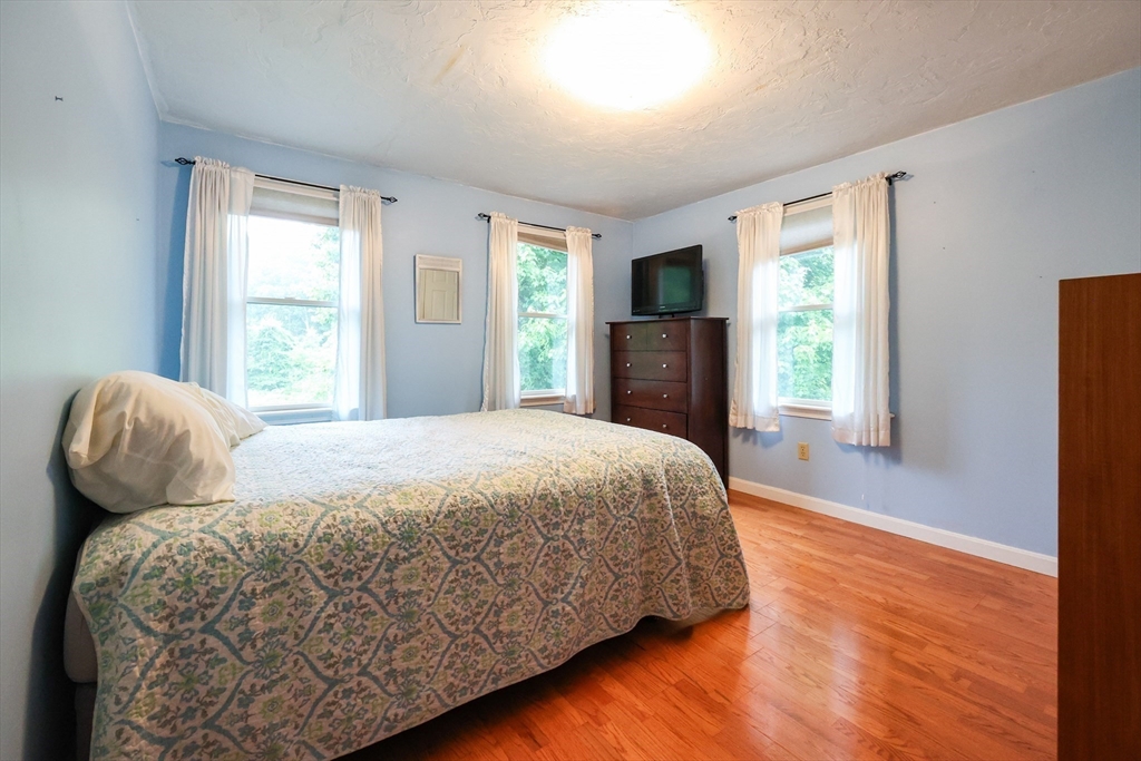 4 Rainbow Drive Medway, MA 02053 - Photo 26 of 42 a bedroom with a bed and wooden floor