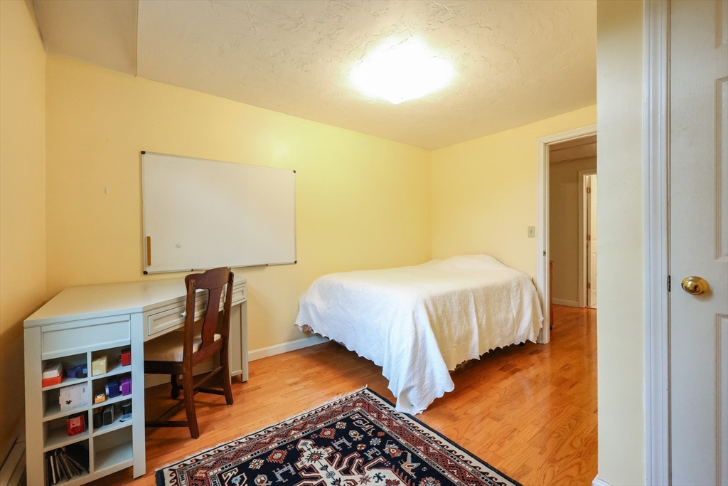 4 Rainbow Drive Medway, MA 02053 - Photo 31 of 42 a bedroom with a bed and a book shelf