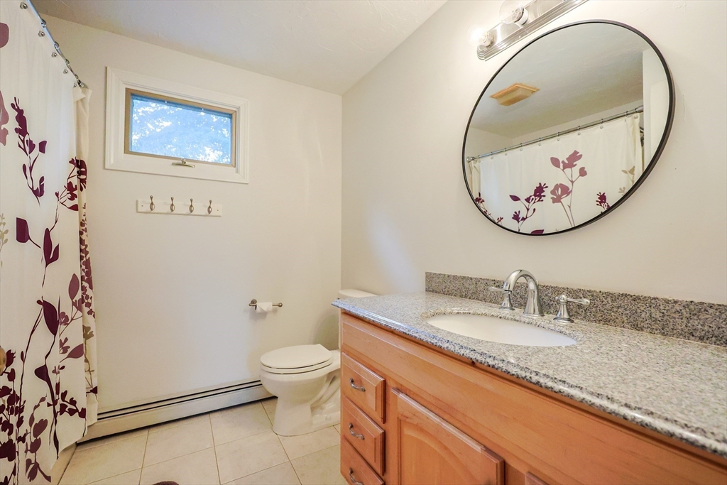 4 Rainbow Drive Medway, MA 02053 - Photo 32 of 42 a bathroom with a granite countertop sink mirror and toilet