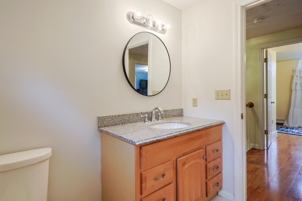 4 Rainbow Drive Medway, MA 02053 - Photo 33 of 42 a bathroom with a granite countertop sink and a mirror