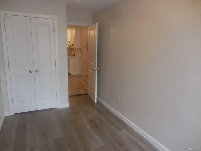 a view of a room with wooden floor and staircase