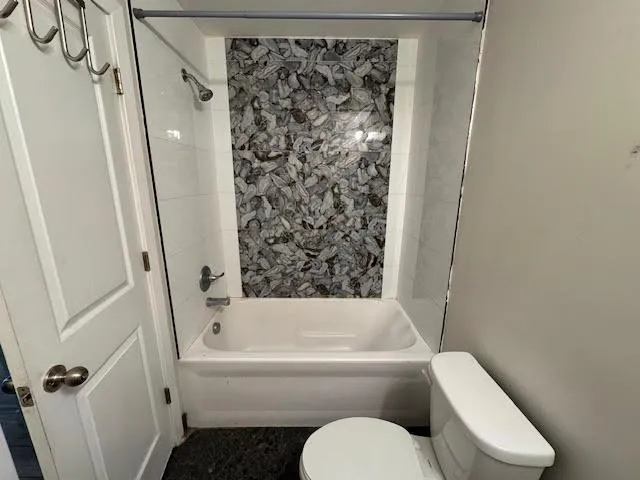 a bathroom with a glass shower door and a mirror
