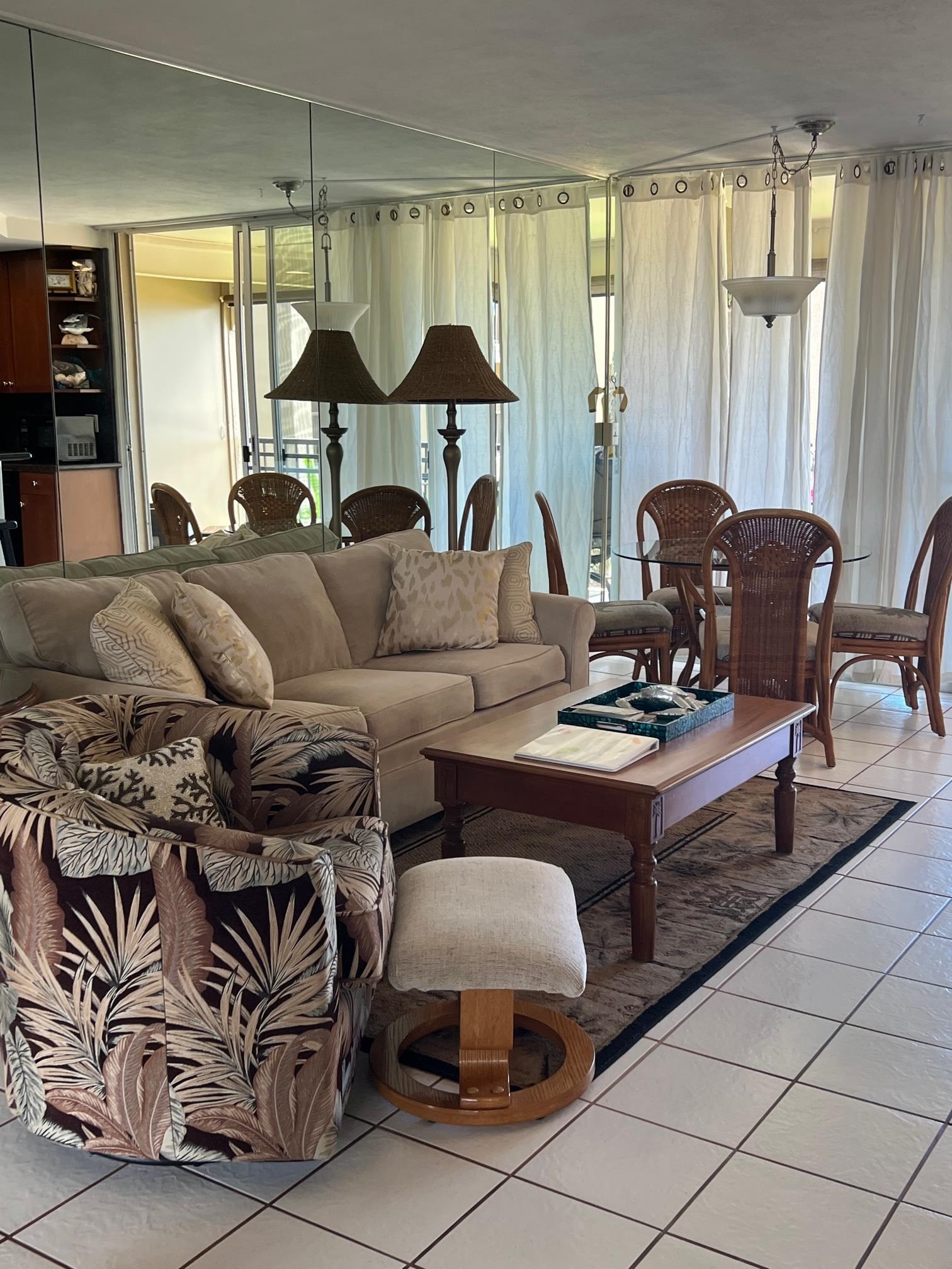 3823 Lower Honoapiilani Road, Unit 211 Lahaina, HI 96761 - Photo 12 of 34 a living room with furniture and a chandelier