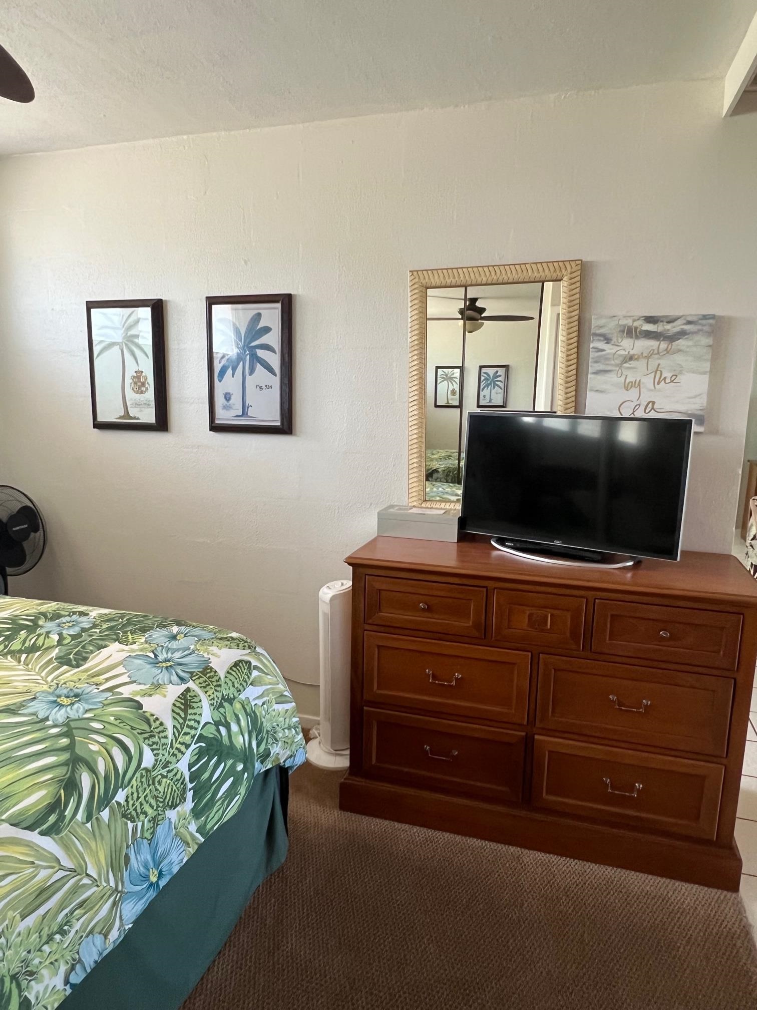 3823 Lower Honoapiilani Road, Unit 211 Lahaina, HI 96761 - Photo 15 of 34 a bedroom with a bed and a television