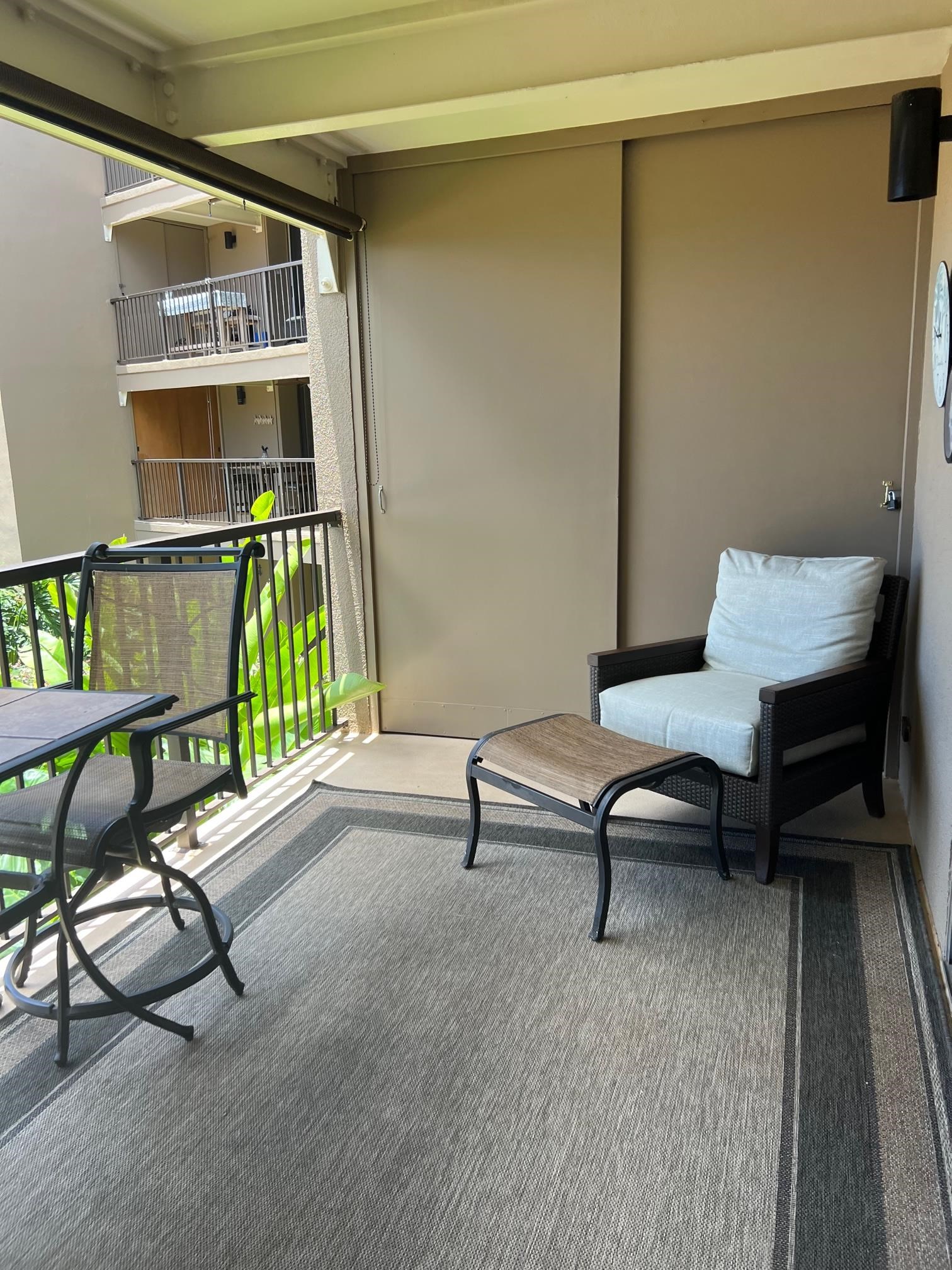 3823 Lower Honoapiilani Road, Unit 211 Lahaina, HI 96761 - Photo 19 of 34 a living room with furniture a rug and a book shelf