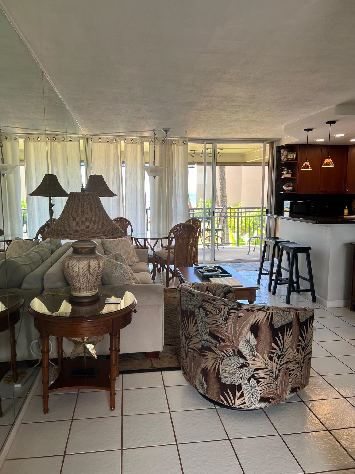 3823 Lower Honoapiilani Road, Unit 211 Lahaina, HI 96761 - Photo 3 of 34 a living room with furniture and a flat screen tv