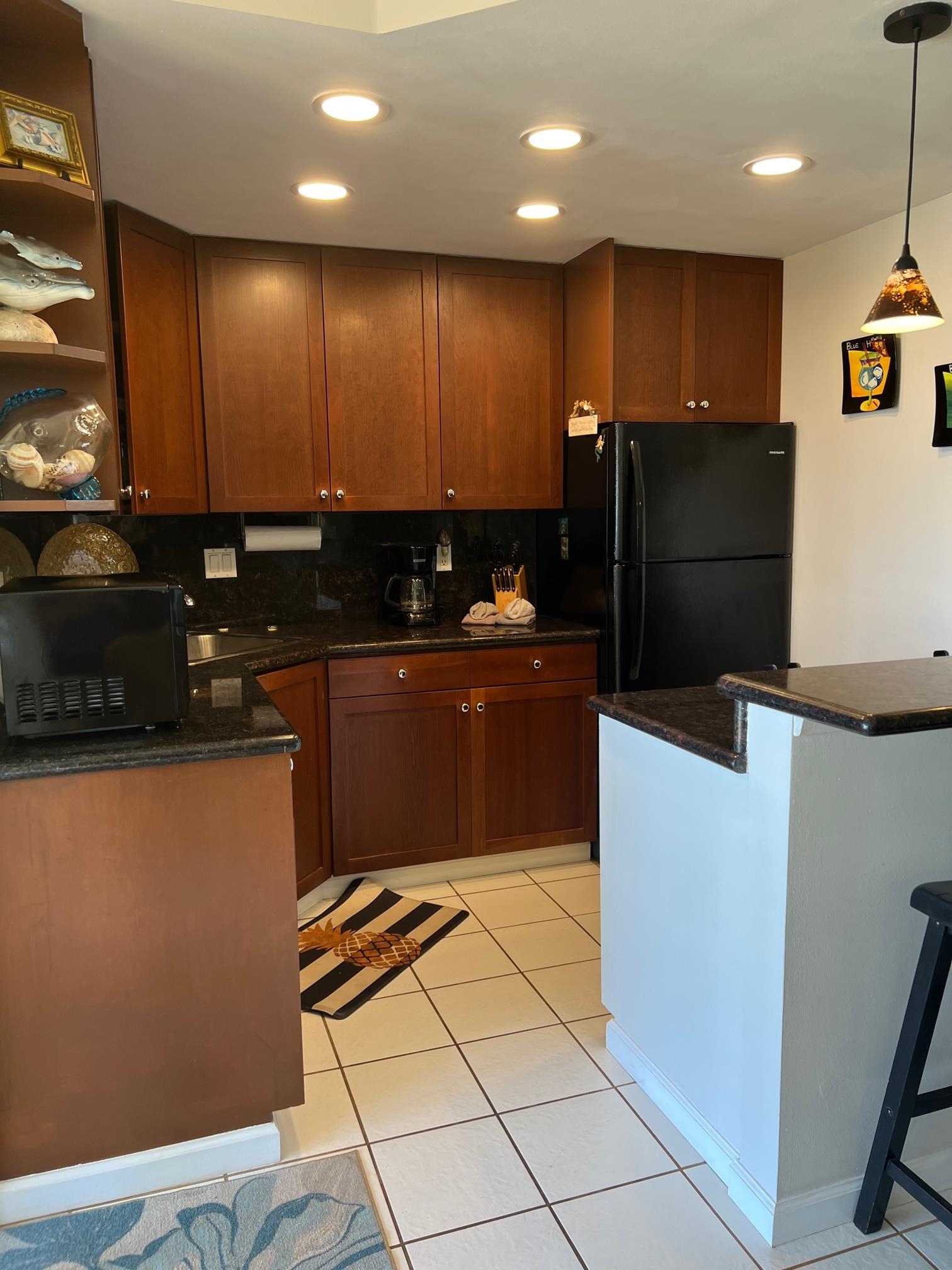 3823 Lower Honoapiilani Road, Unit 211 Lahaina, HI 96761 - Photo 7 of 34 a kitchen with stainless steel appliances a refrigerator sink and microwave