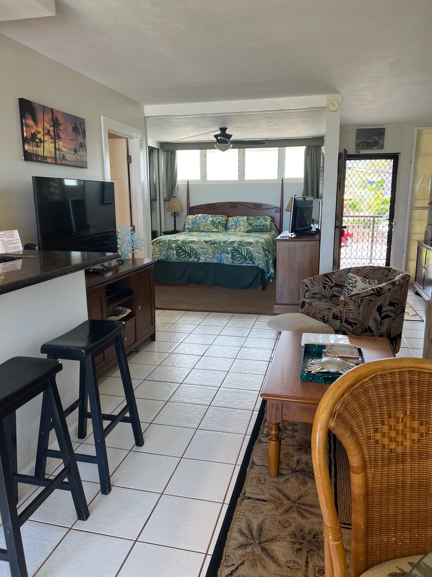 3823 Lower Honoapiilani Road, Unit 211 Lahaina, HI 96761 - Photo 8 of 34 a living room with furniture and a flat screen tv
