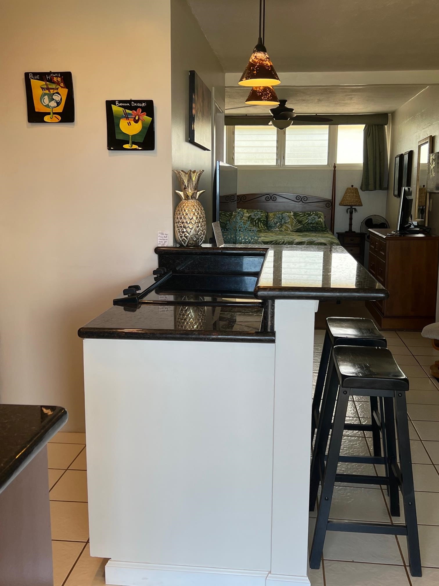 3823 Lower Honoapiilani Road, Unit 211 Lahaina, HI 96761 - Photo 9 of 34 a kitchen with a stove and a refrigerator