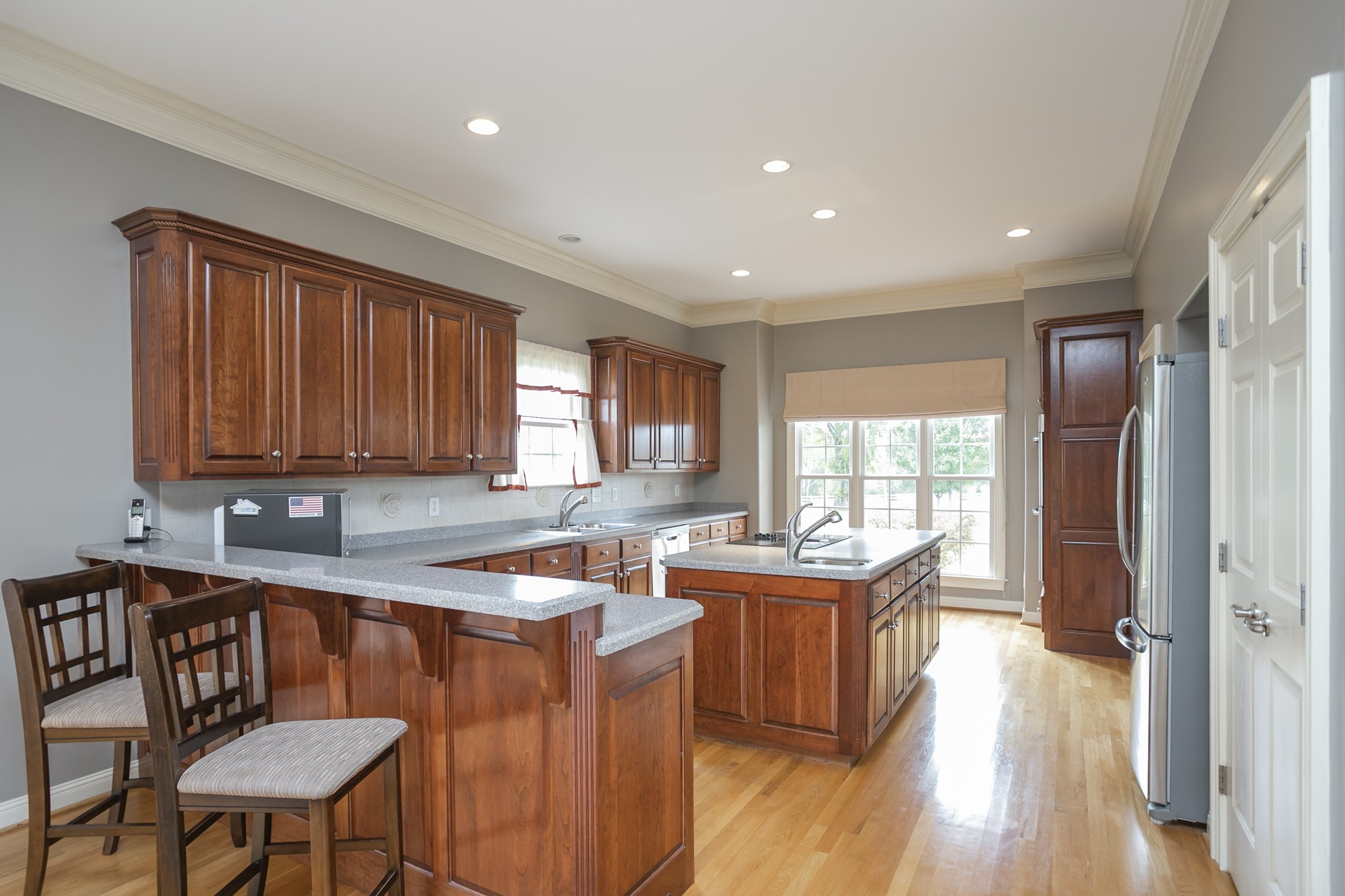 184 Rock Bridge Road Gallatin, TN 37066 - Photo 5 of 50 a kitchen with stainless steel appliances granite countertop a stove a sink dishwasher and a refrigerator with wooden floor