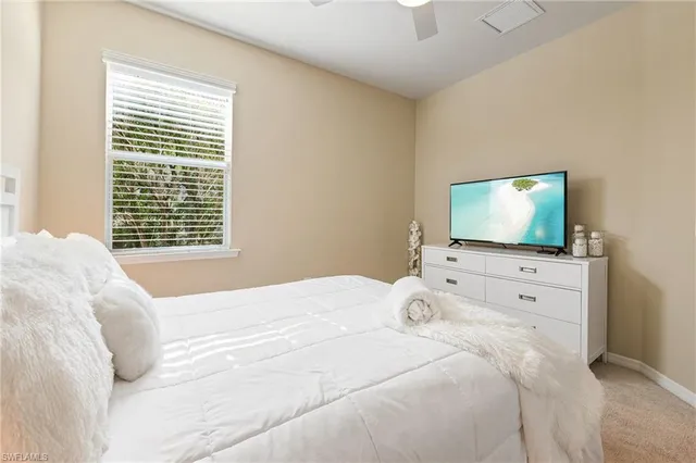 a bedroom with a flat screen tv and a bed