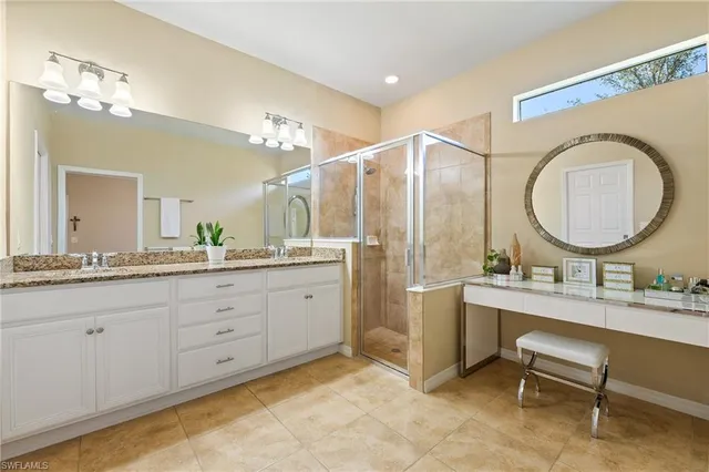 a bathroom with a double vanity sink and a mirror