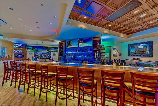 a dining hall with stainless steel appliances a table and chairs