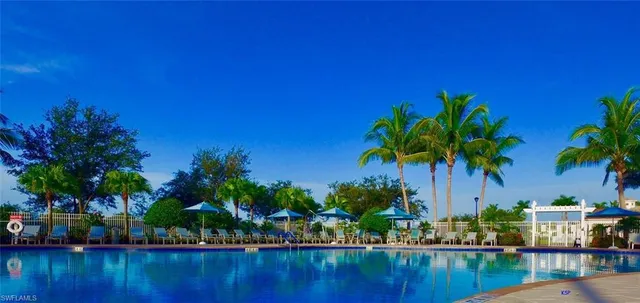 a view of swimming pool with outdoor seating and yard