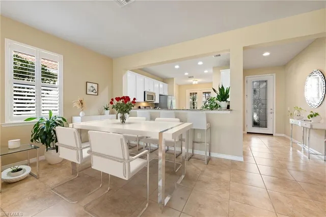 a view of a dining room with furniture and a chandelier