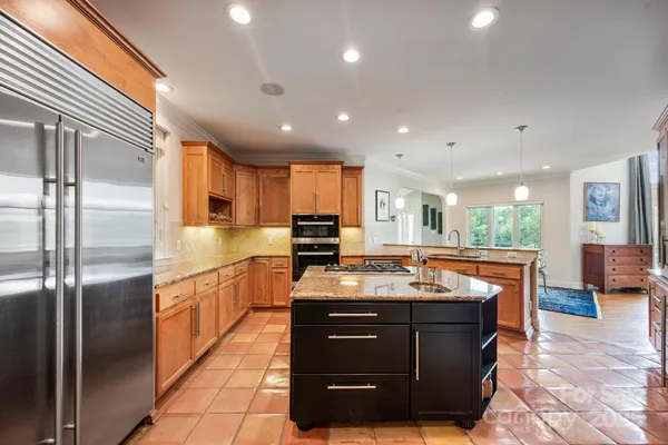 a kitchen with a sink a counter top space and stainless steel appliances