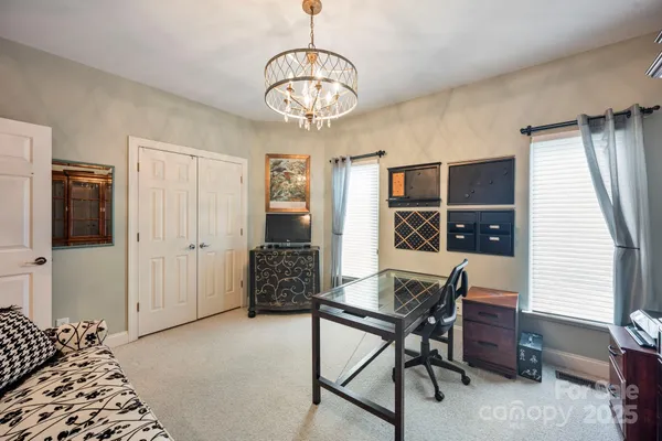 a workspace with wooden floor and a chandelier