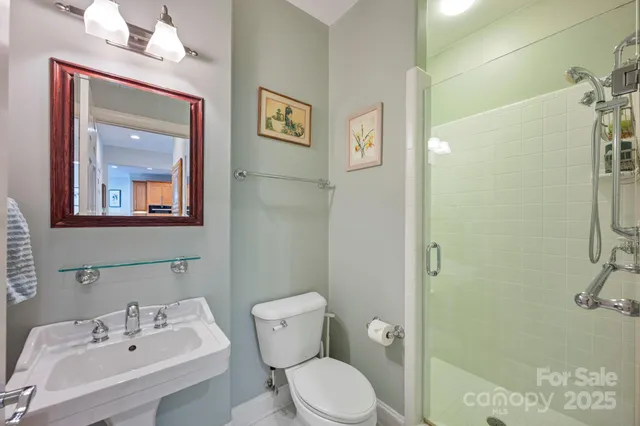 a bathroom with a sink mirror and a toilet