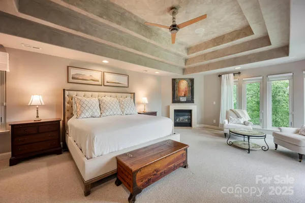 a spacious bedroom with a bed a couch and walk in closet