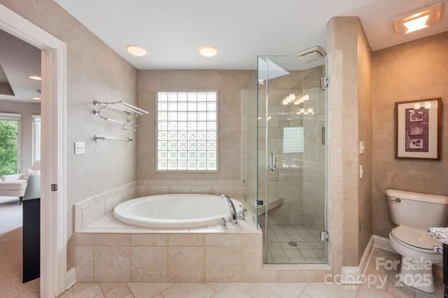 a bathroom with a granite countertop bathtub shower and toilet