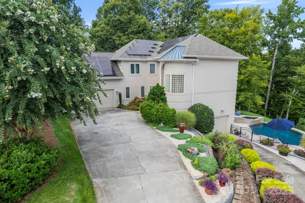 a house with lots of trees in the background