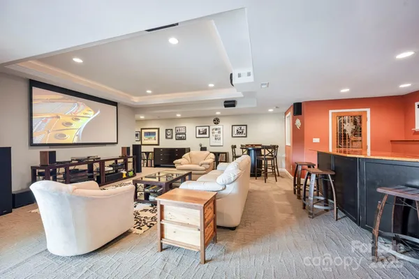 a living room with fireplace furniture and a flat screen tv