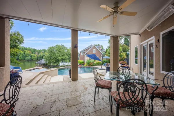 a very nice looking dining room with a large window with table and chairs