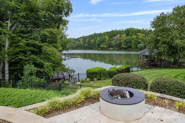 a view of a house with a yard and a fountain