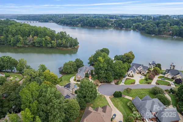 an aerial view of lake residential house with outdoor space and trees around