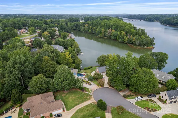 an aerial view of a house with garden space and lake view