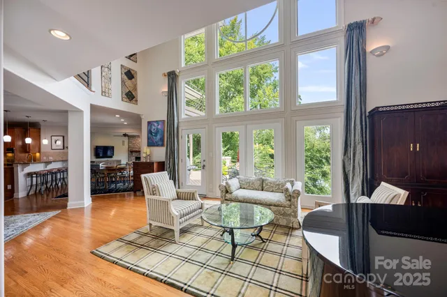 a living room with furniture and a floor to ceiling window