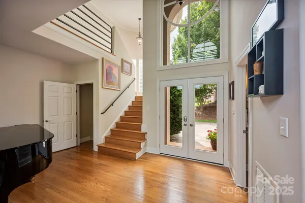 a view of entryway and hall with wooden floor