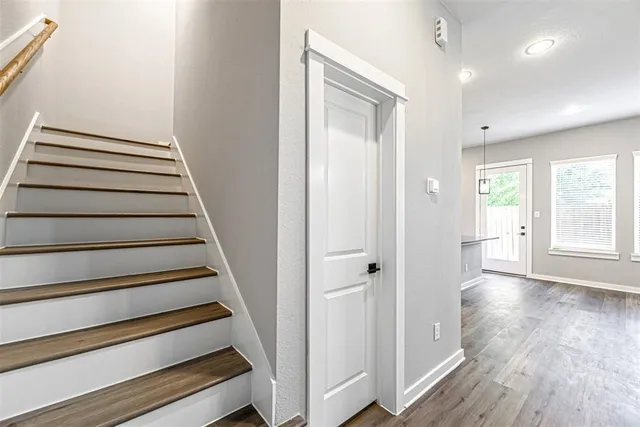 a view of entryway with wooden floor and stairs