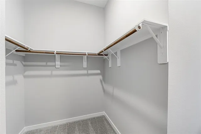 a bedroom with bed couch and window