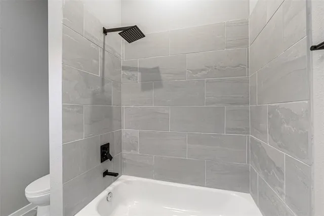 a living room with furniture a flat screen tv and a large window