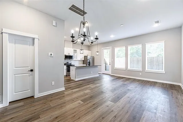 a view of a kitchen with wooden floor and a kitchen