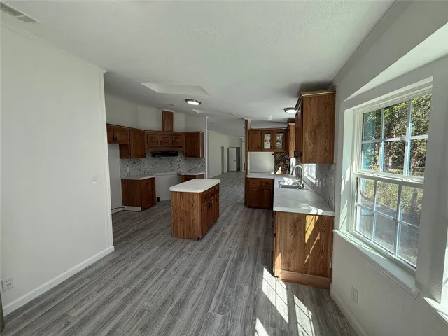 a view of a kitchen and dining room with a sink