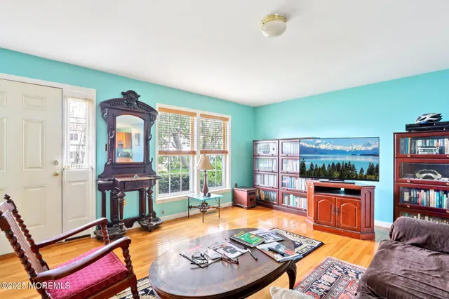 a living room with furniture a rug and a window