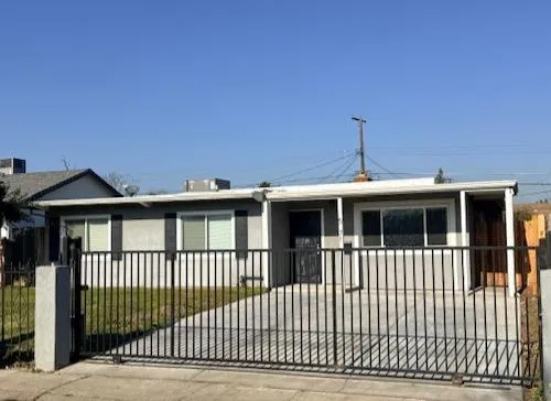 a view of a house with a wooden deck