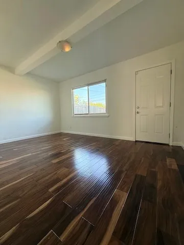a view of an empty room and wooden floor