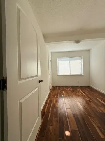 a view of a room with wooden floor