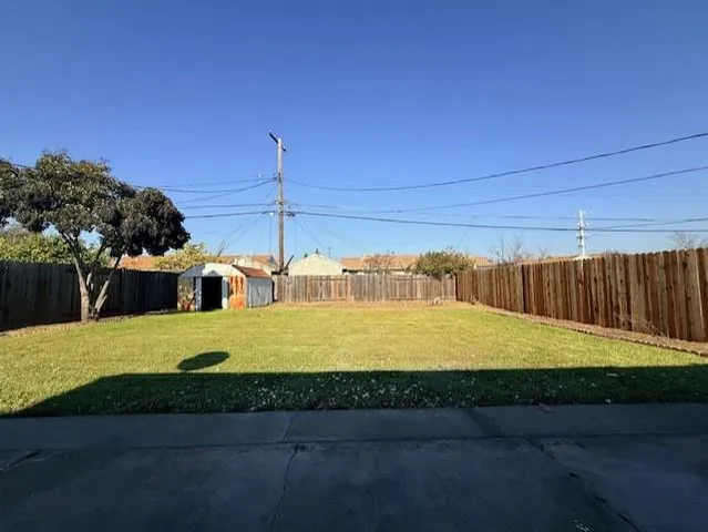 a view of a swimming pool with a yard