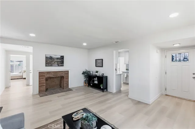 an entryway and livingroom with fireplace