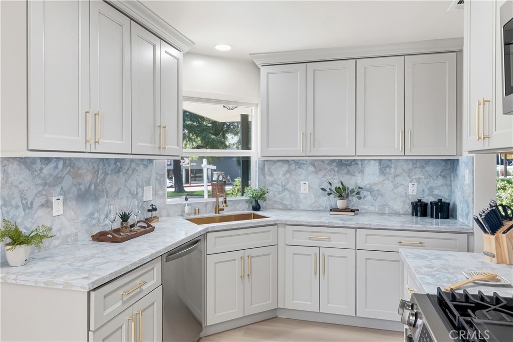 3328 North Verdugo Road Glendale, CA 91208 - Photo 7 of 42 a kitchen with stainless steel appliances white cabinets and a stove top oven