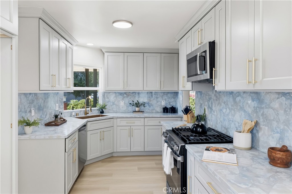 3328 North Verdugo Road Glendale, CA 91208 - Photo 8 of 42 a kitchen with stainless steel appliances granite countertop a stove a sink and a microwave
