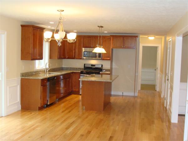 53 Frankland Road Ashland, MA 01721 - Photo 2 of 17 a kitchen with granite countertop a stove a sink and a refrigerator