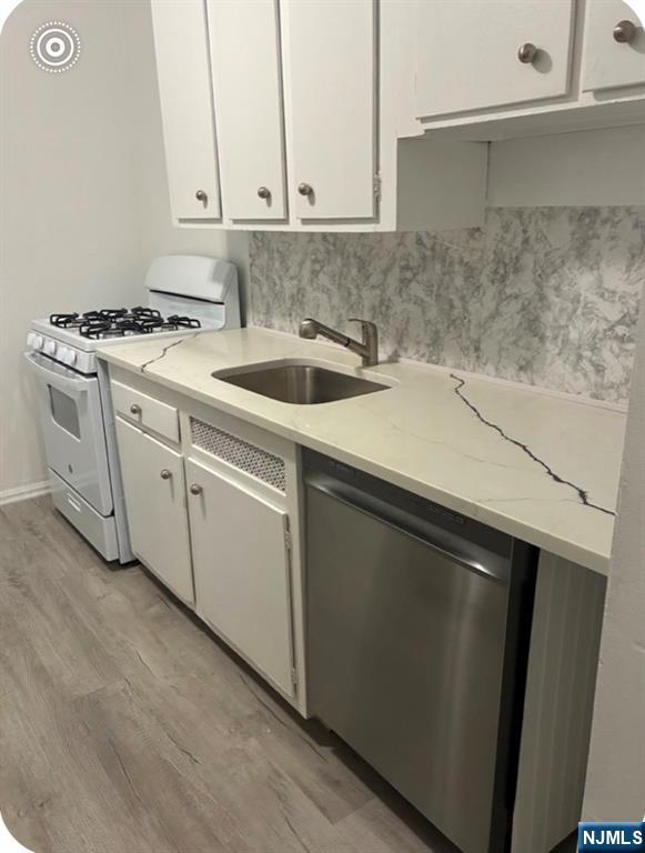 2205 North Central Road, Unit 4D Fort Lee, NJ 07024 - Photo 12 of 37 a kitchen with a sink and cabinets