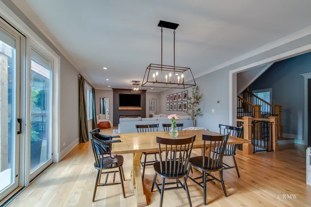 a view of a dining room with furniture wooden floor and chandelier