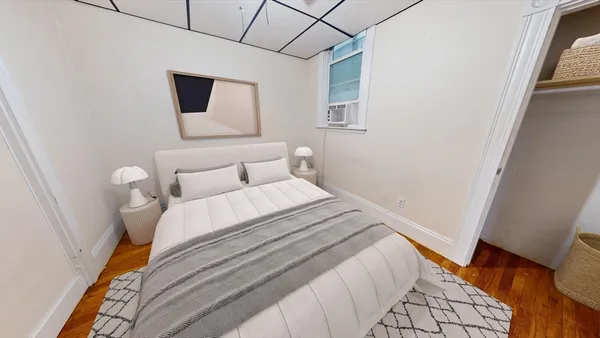 a bedroom with a bed and a night stand